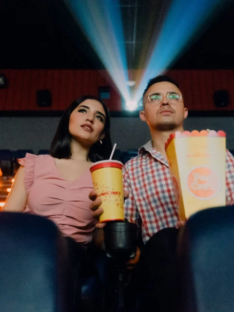 Friends with popcorn in a cinema