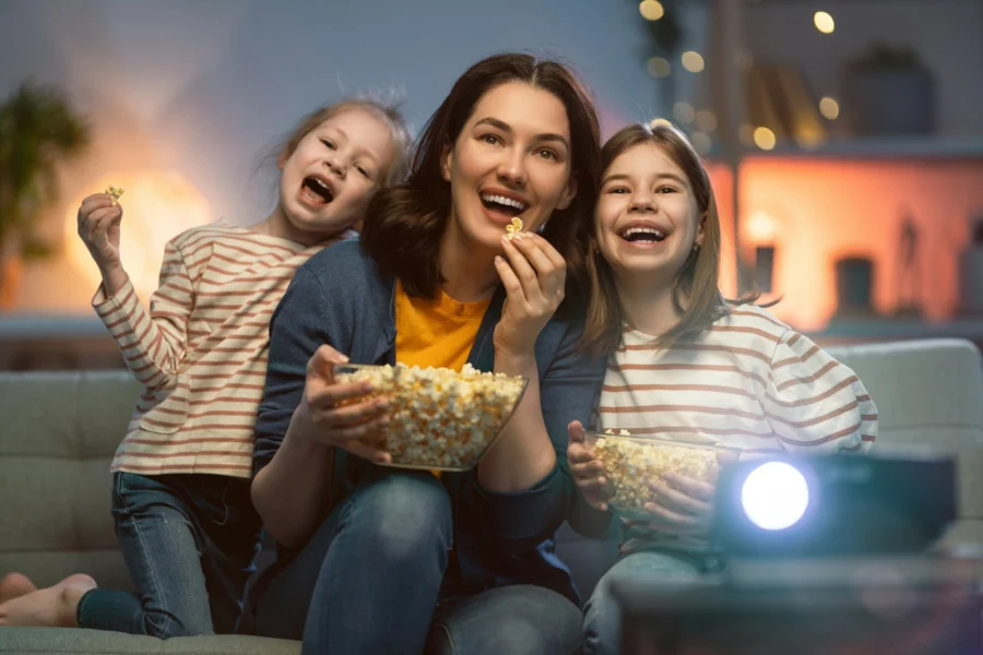 Family eating popcorn during movie night