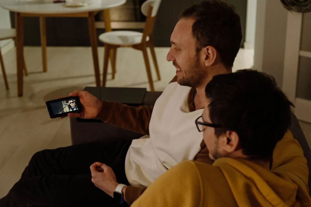 Two friends watching a video on a smartphone
