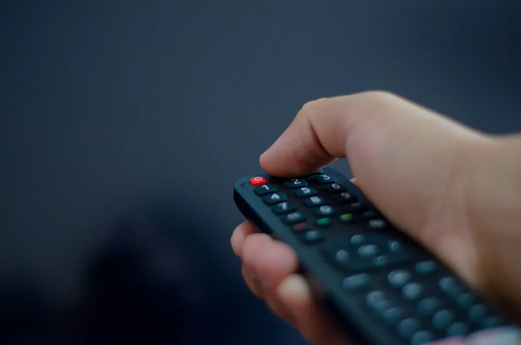 Hand holding a TV remote control