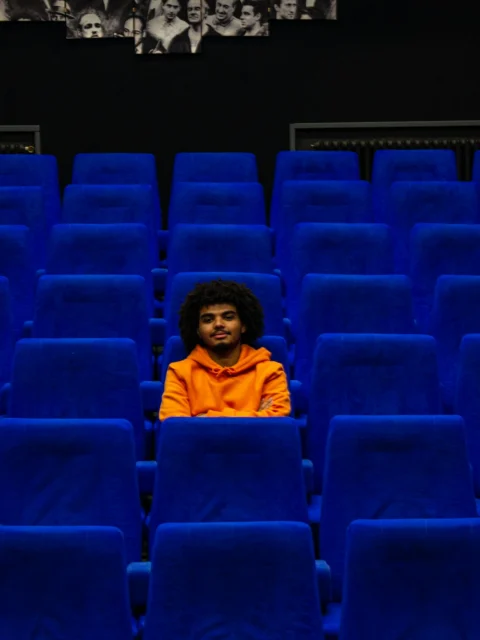 Viewer sitting in an empty cinema