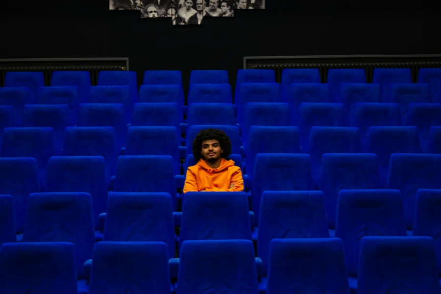 Viewer sitting in an empty cinema